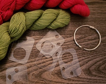 May include: Two skeins of yarn, one red and one green, with a silver ring and several clear plastic templates for crocheting.