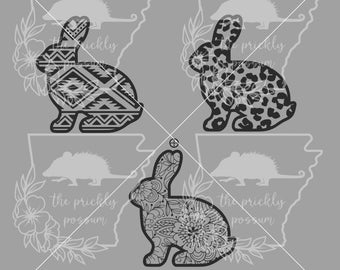May include: Four black and white rabbit silhouettes with different patterns. The patterns include geometric, animal print, and floral.