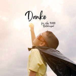May include: A young person dressed as a superhero, wearing a black cape and goggles, reaches towards a bright light in a cloudy sky. The word "Danke" is written in cursive, with additional text below.