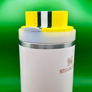 Standard 3 stripe in yellow/forest green/white 
On top of a 40 ounce Stanley Quencher