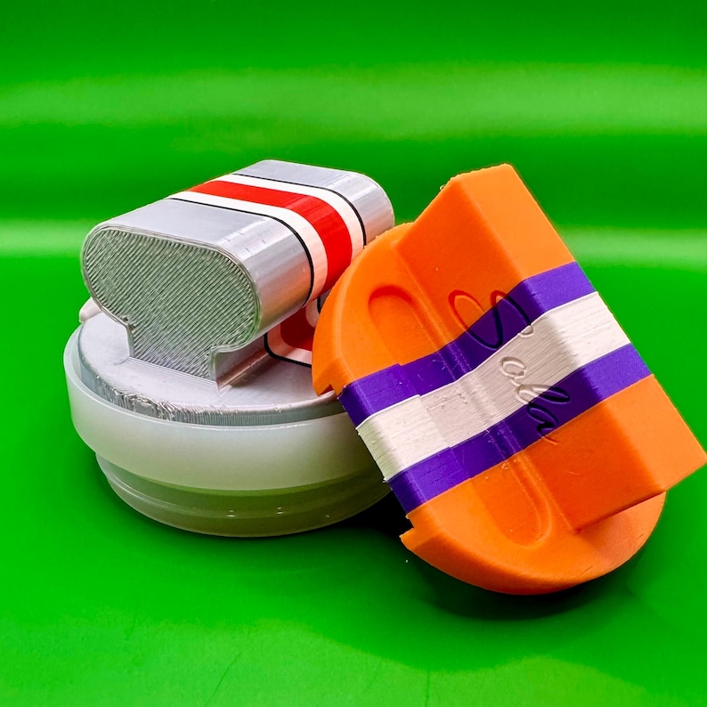 Left -Large 5 helmet stripe-silk silver/red/white
Right- standard 3 stripe-orange/purple/white