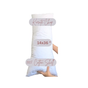 May include: White rectangular pillow with the text "Karate Chop" and "14x36" printed on it. The pillow is made of 100% cotton shell.