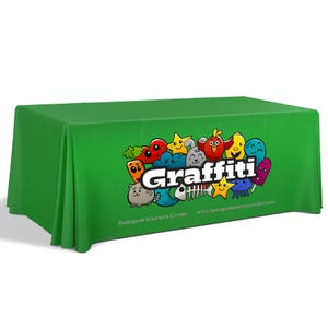 May include: Green table cover with a colorful cartoon graphic of various characters and the word "Graffiti" in white. The text "Biological Sciences Center" and a website address are printed below the graphic.
