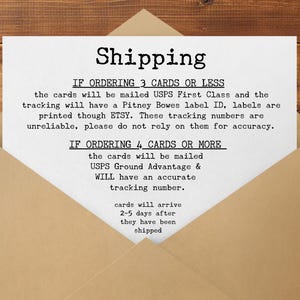 May include: A white card with the word "Shipping" in bold, black letters is inside a brown envelope. The card contains text about shipping details, including USPS First Class and Ground Advantage.