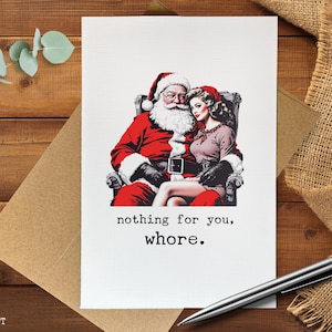 May include: A Christmas card featuring Santa Claus and a woman in a vintage style. Santa is in a red suit, and the woman is in a pink dress. The card has the text "nothing for you, whore."