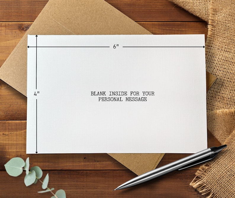 May include: A white greeting card, 4 inches by 6 inches, with the text "BLANK INSIDE FOR YOUR PERSONAL MESSAGE" printed in black. The card is on a brown envelope, with a silver pen nearby.
