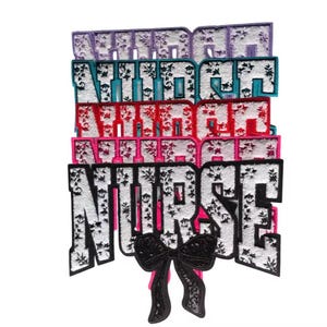 May include: A set of five iron-on patches with a snowflake design. The patches spell out "NURSE" in white letters with black outlines. The patches are layered on top of each other, with the top layer being a light purple patch, followed by a teal patch, a red patch, a pink patch, and finally the white patch with the word "NURSE". A black bow is attached to the bottom of the white patch.