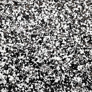 May include: A close-up of a black and white confetti background. The confetti is made of small, round pieces of paper.