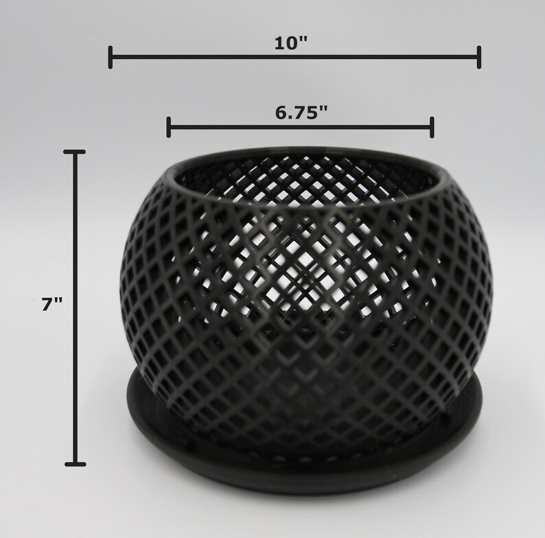May include: Black metal candle holder with a geometric design. The holder is 7 inches tall and has a diameter of 6.75 inches. It comes with a matching base.