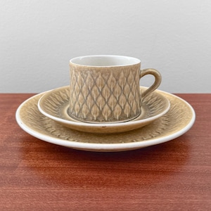 Kronjyden Relief. Tea cup trio set with large cake plate. Designed by Jens Harald Quistgaard, Denmark 1950s.