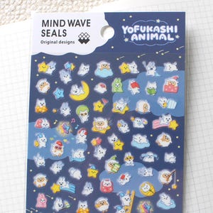 May include: A sheet of Mind Wave Seals Yofukashi Animal stickers featuring numerous small, white cartoon creatures in various night-themed activities, including sleeping on stars, moons, and clouds, set against a dark blue background.