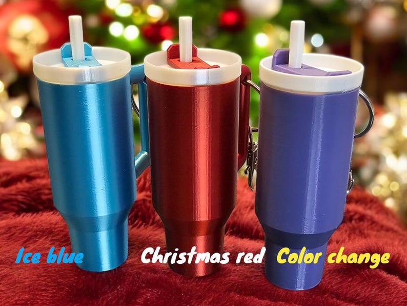 May include: Three travel mugs with lids and straws. The mugs are ice blue, Christmas red, and color change.