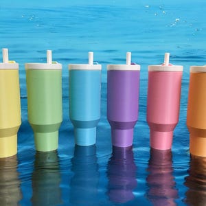 May include: Six pastel-colored stainless steel tumblers with lids and straws. The tumblers are yellow, green, blue, purple, pink, and orange.