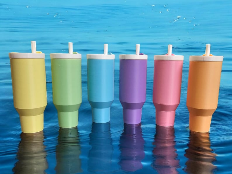 May include: Six pastel-colored stainless steel tumblers with lids and straws. The tumblers are yellow, green, blue, purple, pink, and orange.