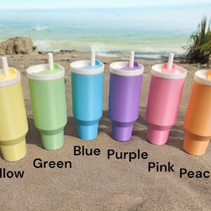 May include: Six pastel-colored tumblers with lids and straws. The colors are yellow, green, blue, purple, pink, and peach.