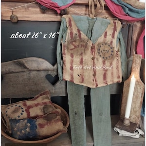 May include: A white ceramic mug with a black handle and the text "But First, Coffee" in a black, handwritten-style font. The mug is on a white surface.