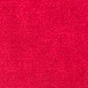 May include: A close-up of a deep red fabric featuring a repeating floral design. The texture is slightly textured, with a matte finish. The overall impression is of a rich, solid colour with a delicate pattern.