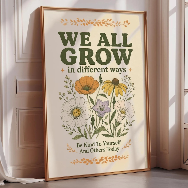 A framed poster with a floral design and the text "WE ALL GROW in different ways" is displayed on a wall.