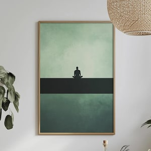 May include: A framed art print with a minimalist design. The artwork shows a silhouetted figure in a seated meditation pose on a dark horizontal band, against a gradient of green hues. The frame is a light wood colour.