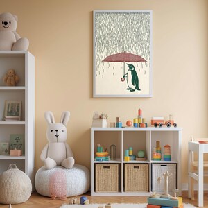 A cozy children's room with a white bookshelf, a plush rabbit, and a colorful toy box filled with toys. Above the bookshelf, there is a framed picture of a penguin holding an umbrella, creating a whimsical atmosphere.