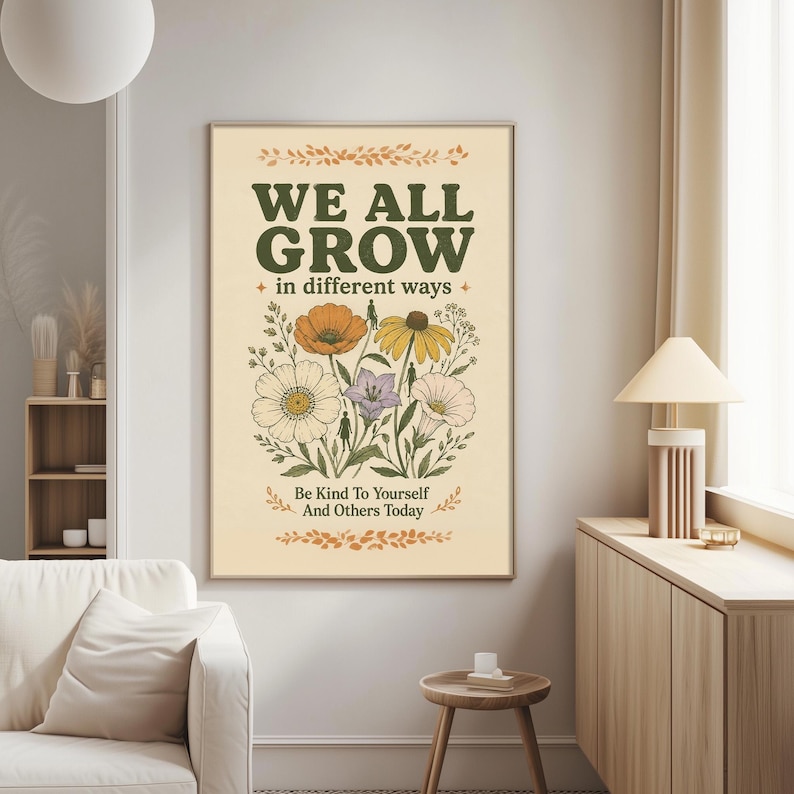 a poster with a floral design and the text "We all grow in different ways" hanging on a wall in a living room.