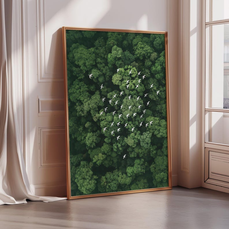 a large framed picture of a lush, green forest with numerous small white birds scattered throughout the scene.