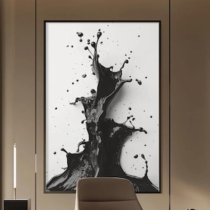 May include: A framed abstract art print featuring a dynamic splash of black paint against a white background. The artwork showcases a high-contrast design with a sense of movement and texture, suitable for modern home decor.