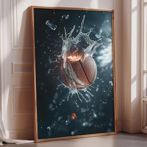 May include: A framed print featuring a basketball bursting through water, creating a dynamic splash effect. The basketball is brown with black lines, set against a dark blue background with water droplets and ice shards. The frame is gold.