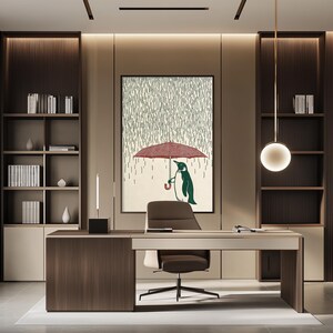 a modern office space with a large framed artwork of a penguin holding an umbrella on the wall. The office features a wooden desk, a comfortable chair, and a bookshelf filled with books. The overall design and decor create a professional and stylish atmosphere.