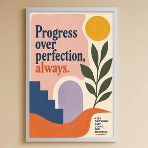 May include: A framed wall art print featuring the text Progress over perfection, always. in dark blue and orange. The design includes a yellow sun, a green leafy plant, a blue staircase, a purple arch, and an orange base with the text KEEP GROWING. KEEP GOING. FOR YOURSELF.