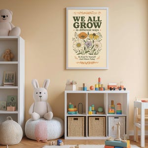 a child's bedroom with a white bookshelf, a stuffed rabbit, and a colorful toy box filled with toys. Above the bookshelf, there is a framed poster with the text "WE ALL GROW in different ways" and an illustration of flowers.