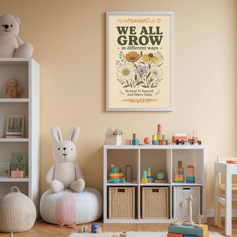 a child's bedroom with a white bookshelf, a stuffed rabbit, and a colorful toy box filled with toys. Above the bookshelf, there is a framed poster with the text "WE ALL GROW in different ways" and an illustration of flowers.