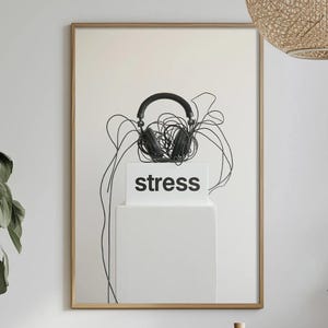 May include: A framed art print showing black headphones on a white box with the word "stress". The headphone cables are tangled and extend downwards. The background is a neutral off-white, with a wooden frame.