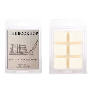 May include: Two wax melt packages. One features a label with "THE BOOKHOP" text, a stack of books, and a quill. The label also lists "LEATHER | WOOD | COFFEE". The other package contains six cream-colored wax cubes. The net weight is 3.0 oz.