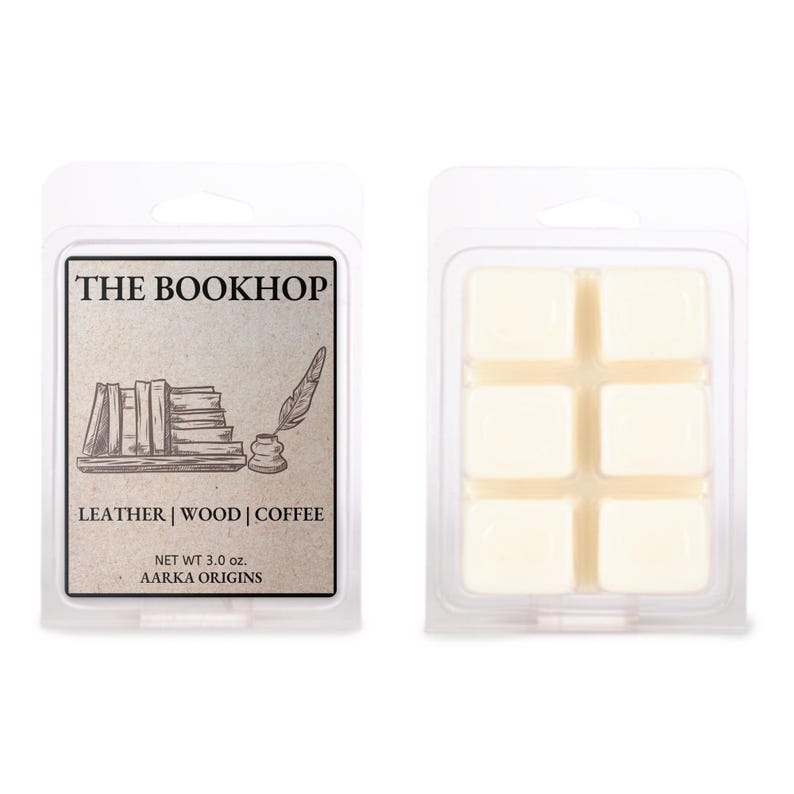 May include: Two wax melt packages. One features a label with "THE BOOKHOP" text, a stack of books, and a quill. The label also lists "LEATHER | WOOD | COFFEE". The other package contains six cream-colored wax cubes. The net weight is 3.0 oz.