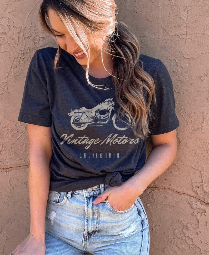 May include: A dark gray t-shirt with a vintage motorcycle graphic and the text "Vintage Motors California".