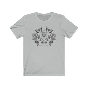 May include: A light gray t-shirt with a black and white illustration of an hourglass, butterflies, and flowers. The text "memento mori" is printed below the hourglass.
