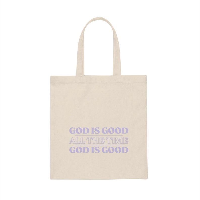 May include: A beige tote bag with a purple design that says "God is good all the time God is good".