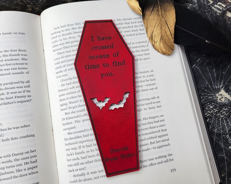 May include: A red coffin-shaped bookmark with a quote from Dracula by Bram Stoker: "I have crossed oceans of time to find you."