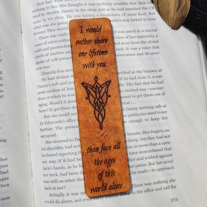 May include: A brown leather bookmark with a Celtic knot design and the quote "I would rather share one lifetime with you than face all the ages of this world alone."
