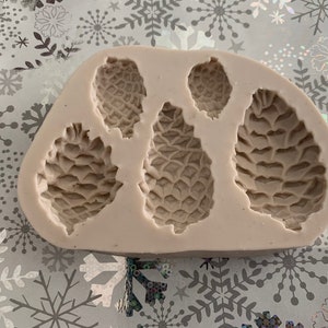 Pinecone Silicone Mold 3D 5 Cavities sizes: XL Pinecone 1.8”L 1”W.5D Large Pinecone 1.5”L .7”W .4”D Medium Pinecone 1.25”L .8”W .5”D