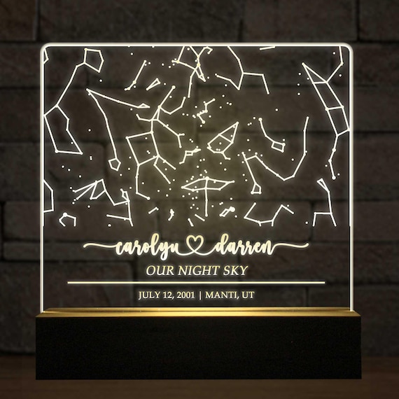 A star map that actually glows — the LED-lit acrylic constellation lamp with custom date/place turns a tired format into a genuinely atmospheric night light.
