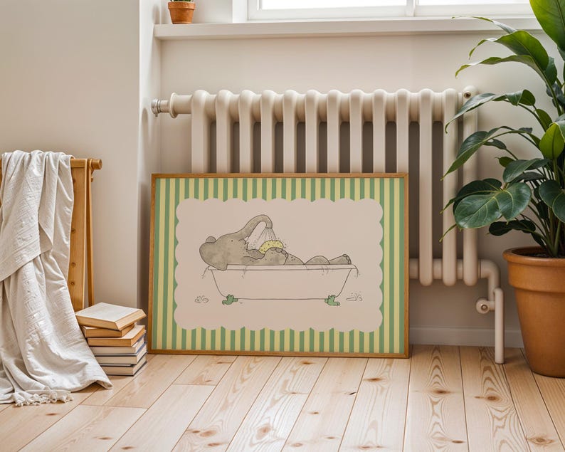May include: A framed print featuring a cartoon elephant taking a bath in a tub. The artwork has a light green and cream color scheme, with a striped border. The elephant is gray, and the tub has green feet.