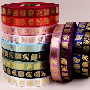 May include: A stack of colorful satin ribbon rolls with a gold geometric pattern. The ribbon is perfect for crafting, gift wrapping, and decorating.