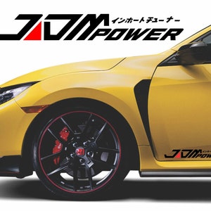 May include: A yellow Honda Civic Type R with black JDM POWER decals on the side and a red and black wheel. The car has a black front splitter and side skirts.