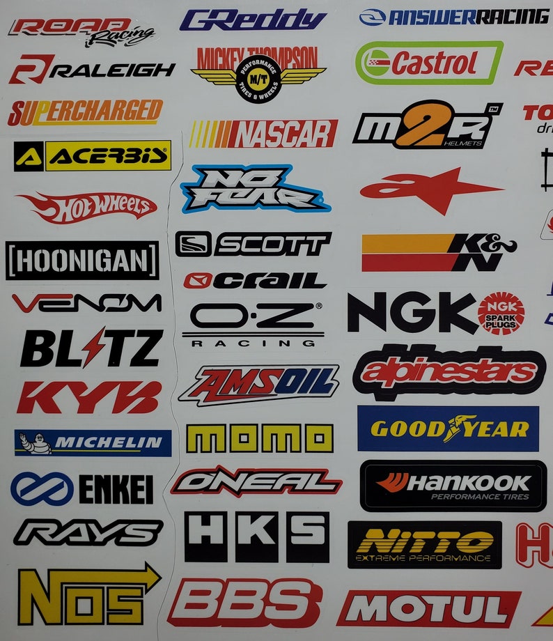 May include: A collection of colorful racing and automotive brand logos, including GReddy, NASCAR,  Hot Wheels,  NGK,  AmsOil,  Michelin,  Enkei,  Rays,  BBS,  and  Motul.