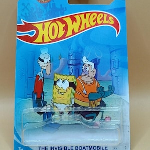 May include: A Hot Wheels toy car package featuring characters from the animated series Spongebob Squarepants. The package is blue with the Hot Wheels logo and the text "THE INVISIBLE BOATMOBILE". The characters include Spongebob, Mermaid Man, and Barnacle Boy.