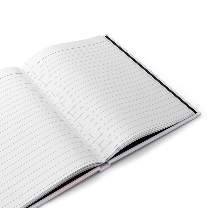 May include: An open notebook with lined pages and a black cover. The notebook is lying open on a white surface.