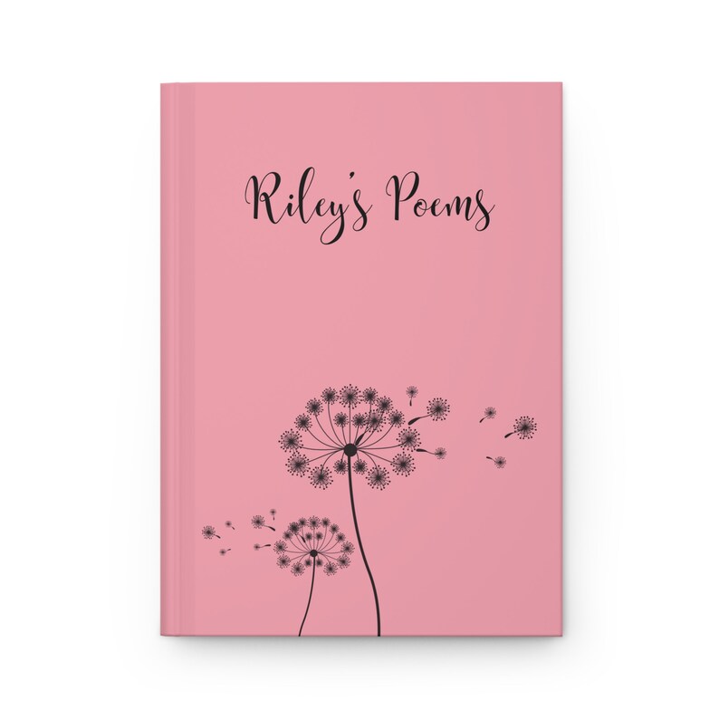 May include: A pink hardcover journal featuring the black text Riley's Poems printed in a cursive font at the top. Below the text, two black dandelion illustrations are depicted with seeds blowing toward the right side of the cover.