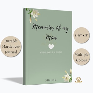May include: A sage green hardcover journal with white lily illustrations at the top left and bottom right corners. The cover features the black text Memories of my Mom, a white heart icon, the text YOU WILL ALWAYS BE IN MY HEART, and SARAH LOVENE.